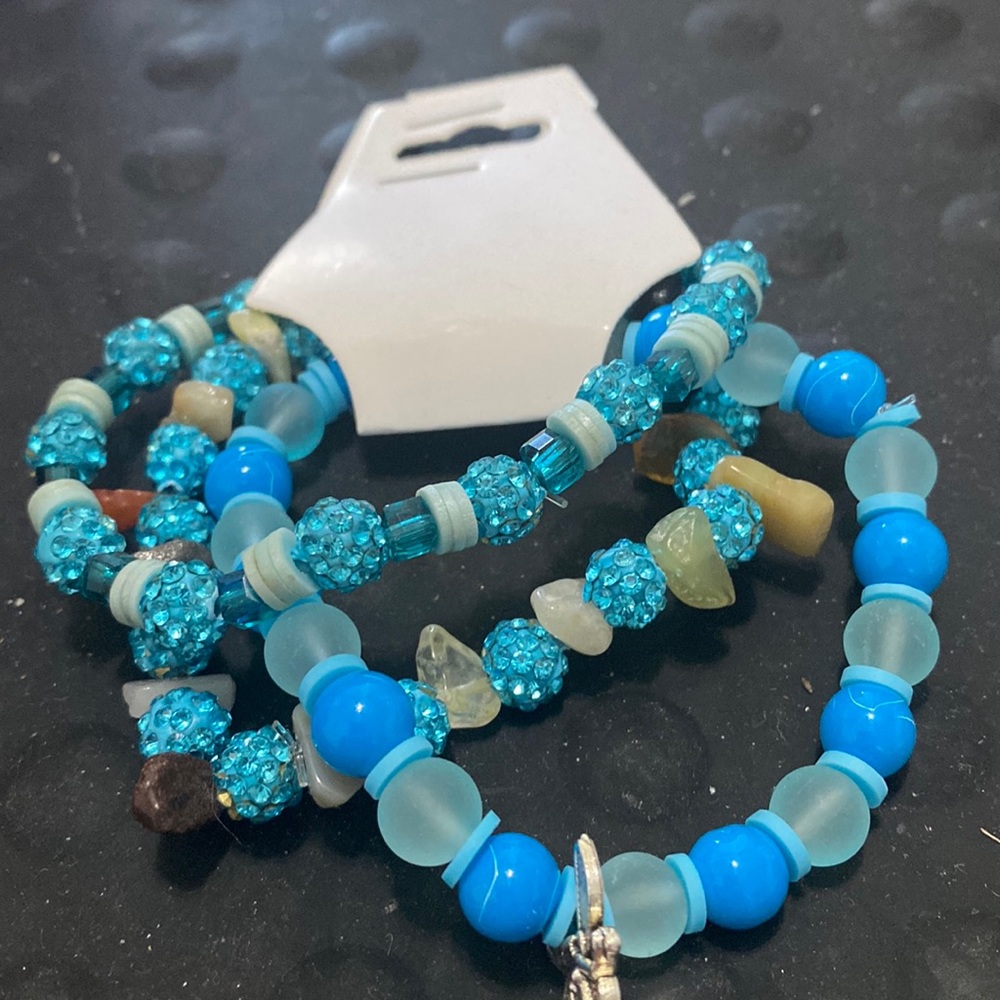 Three blue braces with spacers and charm